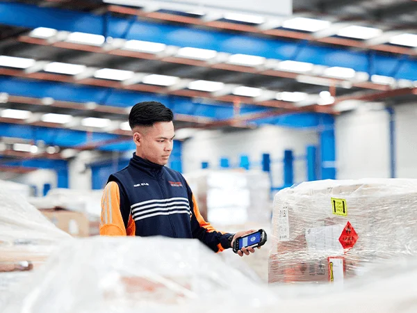 Scanning Pallet - Chemcouriers - Chemcouriers team member scanning pallet for delivery